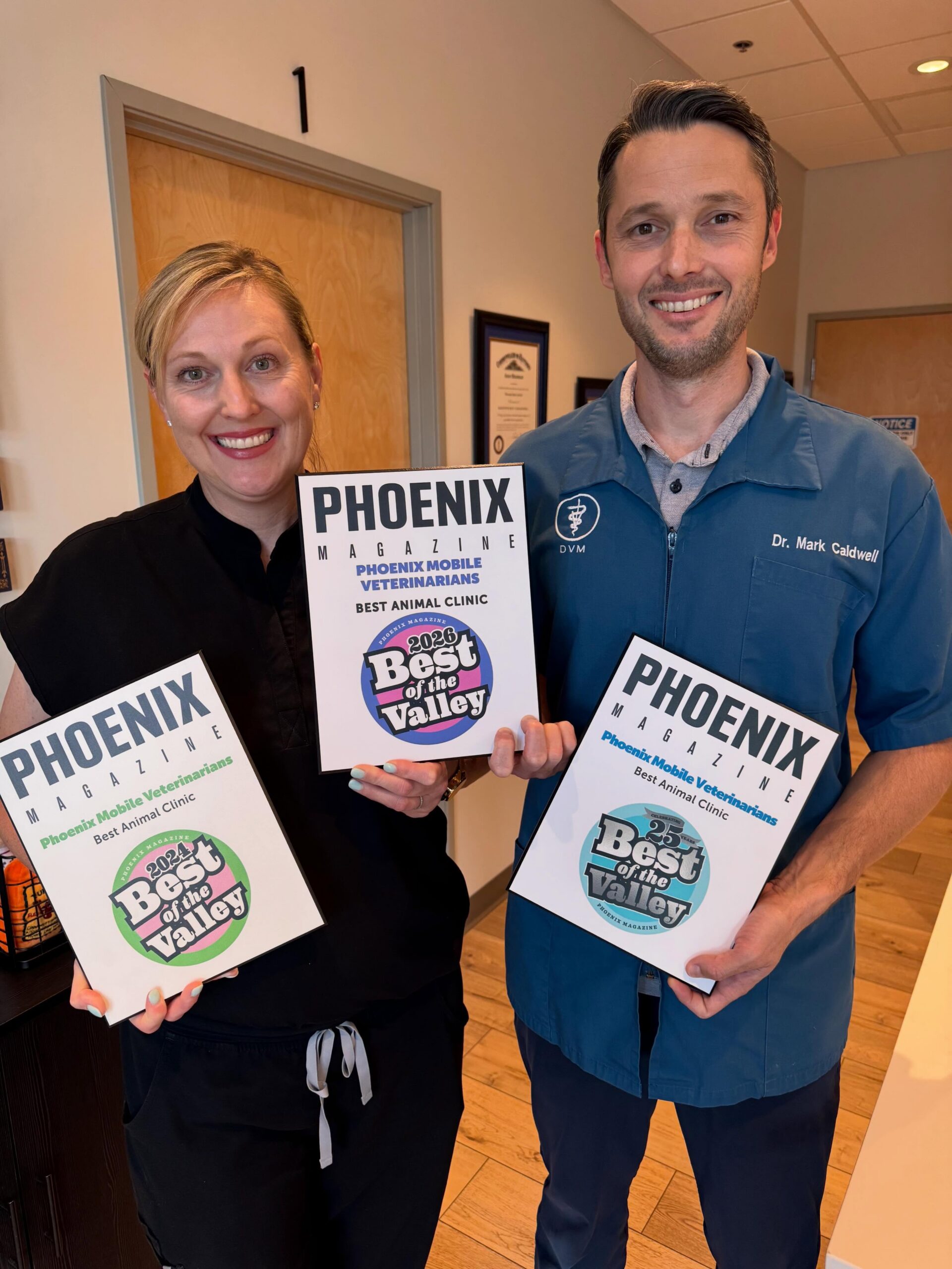 Doctor Veterinarians, Mark and Kristin showcasing their awards at Scottsdale Animal Hospital, AZ